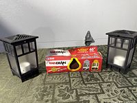 Lot overview showing Amerimax Rain Drain box flanked by two black OFF lanterns
