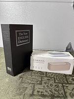 Closed book safe standing beside boxed mini cleaner