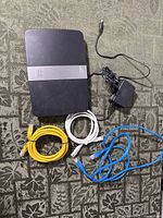 Router, power adapter and three Ethernet cables layout