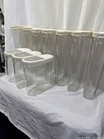 Group shot showing seven tall and four short canisters