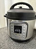 Front view of Instant Pot Duo Mini with control panel and lid attached