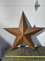 Front view of large 3D metal star showing size and finish