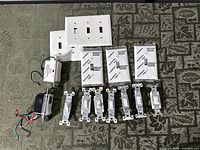 All switches, timers, and wall plates laid out on table