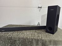 Soundbar and wired subwoofer on table