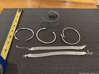 overview of all six sterling bracelets beside ruler