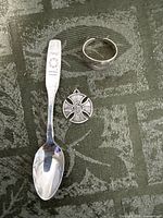 Front view of spoon, pendant and ring