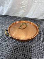 Pan with lid closed showing brass handles