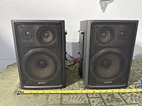 Front view showing both Sony SS-H77 speakers with grilles and size reference