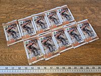 All ten sealed 1999 Upper Deck McDonald's Retro packs laid out with ruler for scale