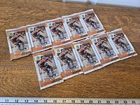 All ten sealed packs laid out on wood surface