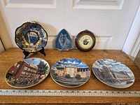 Full lot showing all plates, agate décor, and barometer with ruler for scale