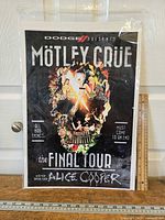 Front view of entire poster in protective sleeve beside yardstick showing size