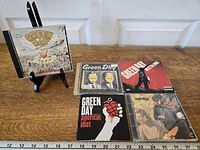Group shot of five Green Day CDs
