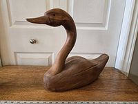 Left side view of full wooden goose sculpture