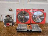 Group shot showing two saw blades in packaging, Jobmate drill bit set, Fuller socket set