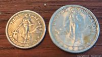 Two silver coins from 1944, United States Filipinas, placed side by side on a wooden surface.