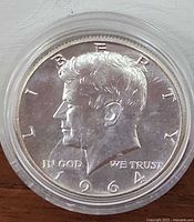 Front (obverse) side of the 1964 American Silver Half Dollar Coin showing John F. Kennedy profile, year 1964, and inscriptions.