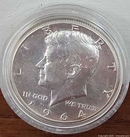 Obverse side showing John F. Kennedy profile and inscriptions.