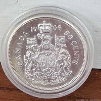 Obverse side showing the Canadian coat of arms and denomination