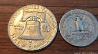 Photo showing both coins: a 1963 Liberty Bell Half Dollar and a 1944 Quarter Dollar.