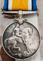 Obverse side of the medal showing a mounted nude horseman trampling a shield, sword, and skull with dates 1914 and 1918.