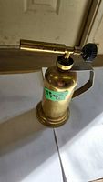 Full view of brass blow torch showing height and components