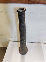 Full view of brass fire hose nozzle upright