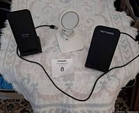 Front view of three charging stands on table