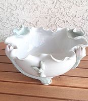 Top angle of lotus form porcelain bowl showing interior and applied lotus buds