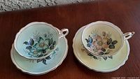 Set of two Paragon teacups with saucers displayed