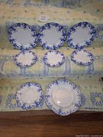 Group of eight blue floral plates in two rows