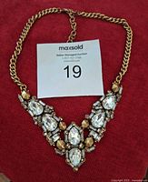 Front view of Stella & Dot Zora bib necklace on red background