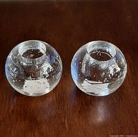 Both spherical glass candle holders side by side