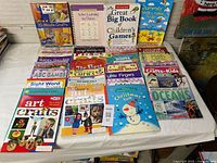 Overview of all 45 children’s educational and craft books spread on table