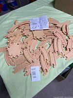 pile of tan Flip Track pieces and instruction sheet on bed