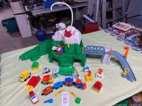 overview of Fisher-Price Flip Track Rail & Road playset with mountain, track, vehicles and accessories