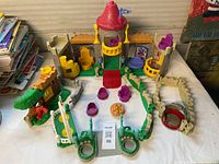 Full playset laid out showing castle, walls, gazebo, treehouse, swing and accessories