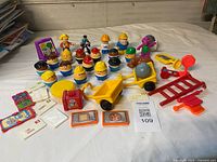 Overall view of figures, carts, wheelbarrow, tiles and other accessories