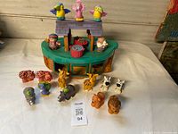 Overall view of ark playset with animal and human figures arranged in front