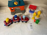 Overview of train cars with figures, station, booth, and accessories