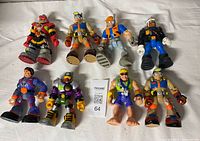 Nine Rescue Heroes figures laid out on white surface