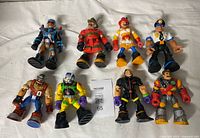 All nine Rescue Heroes figures laid out on white cloth