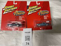 Front view of both sealed Johnny Lightning cars on original cards
