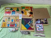 Overall view of all puzzles in lot laid out on green surface