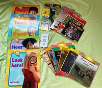 All 18 books laid out, grouped by size and series