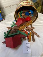 Can and spilled contents showing variety of logs and roof pieces