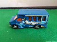 Left side view of blue airport shuttle bus showing graphics and wheels