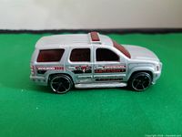 Left side view of silver ’07 Chevy Tahoe die-cast car with graphics