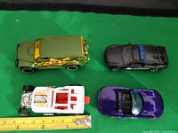 Top view all four cars with tape measure for scale