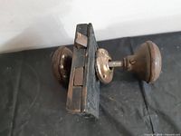 Side view of lock body with attached knobs showing size and wear